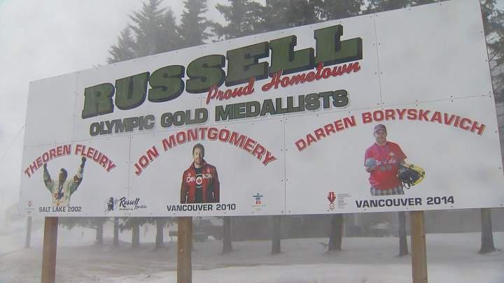 Darren Boryskavich\’s picture sits on Russell\’s welcome sign next to Olympians Theo Fleury and Jon Montgomery.