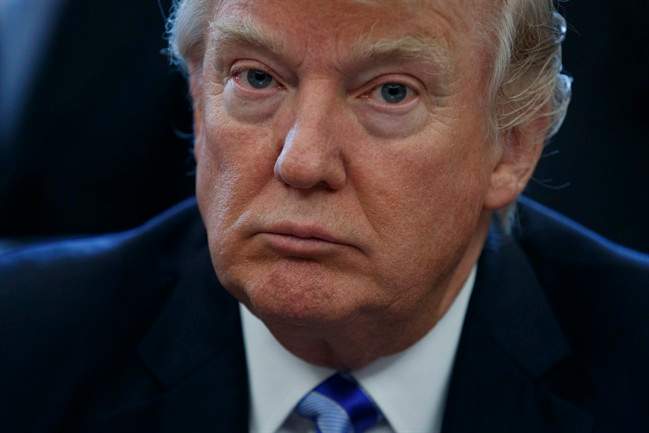 President Donald Trump pauses in the Oval Office of the White House in Washington Friday, March 24, 2017.