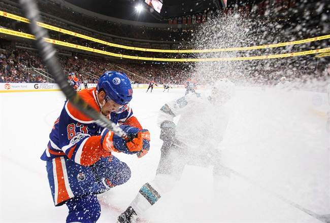 San Jose Sharks' Mikkel Boedker (89) and Edmonton Oilers' Matthew Benning (83) vie for the puck during third period NHL action in Edmonton, Alta., on Thursday, March 30, 2017. 