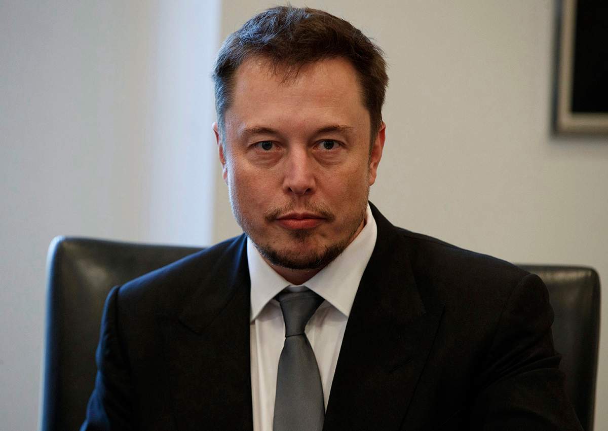 In this Dec. 14, 2016, file photo, Tesla CEO Elon Musk listens as President-elect Donald Trump speaks during a meeting with technology industry leaders at Trump Tower in New York., .