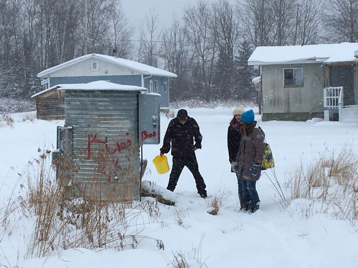 Pikangikum residents get water from external tanks. 