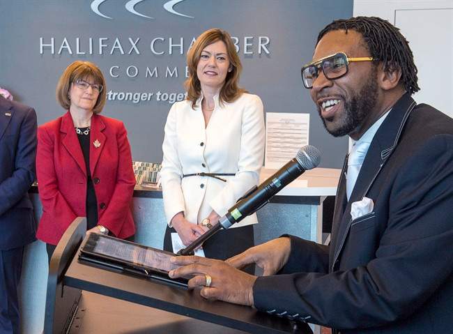 Lennett Anderson, right, senior pastor at Emmanuel Baptist Church, addresses the audience as Justice Minister Diana Whalen, left and Christine Hanson, CEO of the Nova Scotia Human Rights Commission, look on at the announcement of an online training course dealing with consumer racial profiling to educate retail businesses, in Dartmouth, N.S. on Monday, March 27, 2017. 