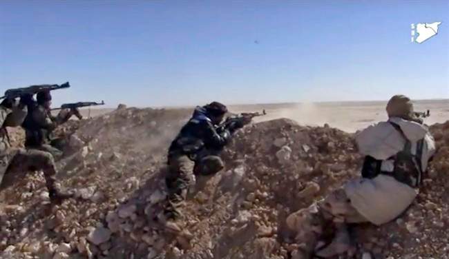 Syrian Democratic Forces (SDF) fighters open fire on an Islamic State group position in Raqqa, Syria, March 6, 2017.