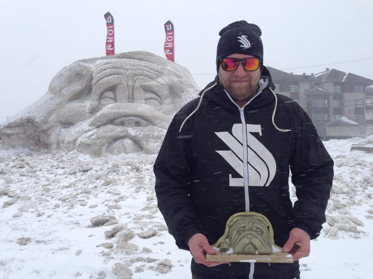 Jessie Armand and his giant bulldog snow sculpture near Highway 640 in Saint-Eustache. Tuesday, March 14, 2017.