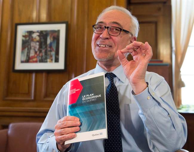 Quebec Finance Minister Carlos Leitao displays his budget speech, on the eve of a provincial budget speech, Monday, March 27, 2017 in Quebec City. 