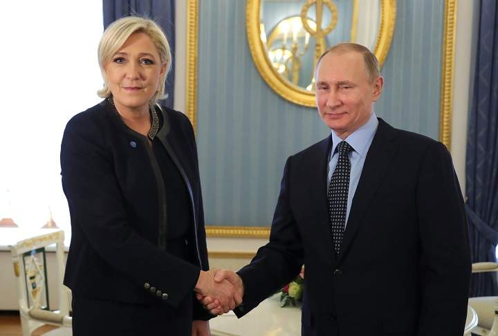 Russian President Vladimir Putin shakes hands with Marine Le Pen, French National Front (FN) political party leader and candidate for the French 2017 presidential election, during their meeting in Moscow, Russia March 24, 2017. 