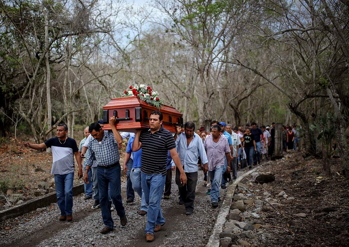 In this March 8, 2017 photo, members of the Solecito search group carry the coffin of Pedro Huesca, a police detective who disappeared in 2013 and was recently found in a mass grave, as they walk to the cemetery in Palmas de Abajo, Veracruz, Mexico.