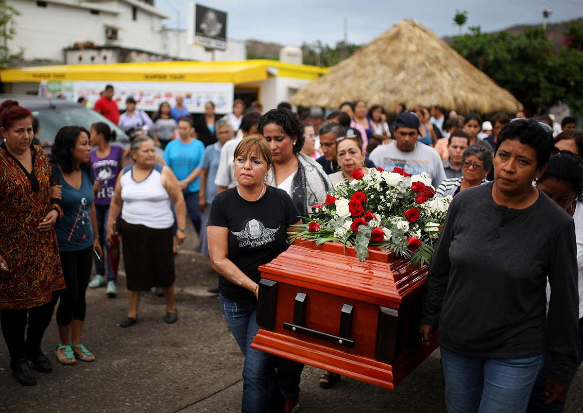 In this March 8, 2017 photo, members of the Solecito search group carry the coffin of Pedro Huesca, a police detective who disappeared in 2013 and was recently found in a mass grave, as they walk to the cemetery in Palmas de Abajo, Veracruz, Mexico.