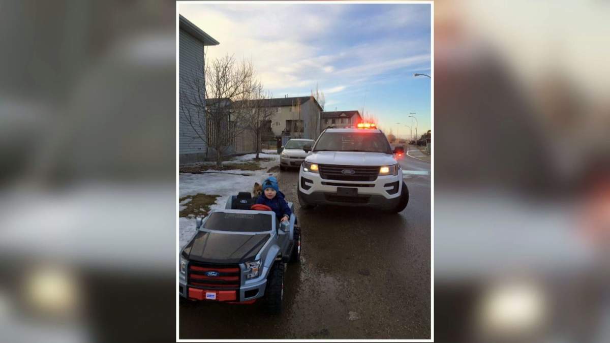 Nathan Snow, 3, gets pulled over by a friendly RCMP officer in Fort McMurray, Alta., on Sunday, March 26, 2017.