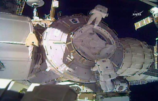 In this image made from video provided by NASA, U.S. astronauts Peggy Whitson, above, and Shane Kimbrough work on the outside of the International Space Station on Thursday, March 30, 2017.