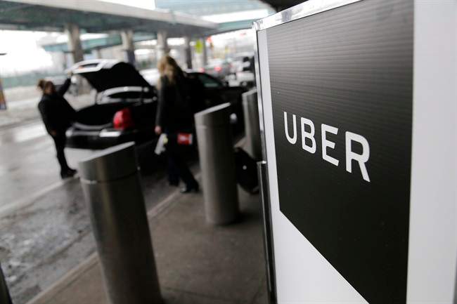 A sign marks a pickup point for the Uber car service at LaGuardia Airport in New York.