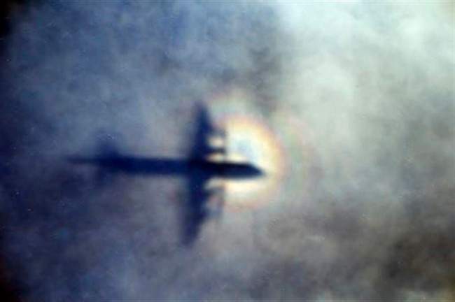 In this March 31, 2014 file photo, the shadow of a Royal New Zealand Air Force P3 Orion is seen on low level cloud while the aircraft searches for missing Malaysia Airlines Flight MH370 in the southern Indian Ocean, near the coast of Western Australia.