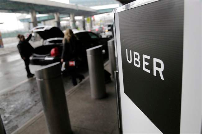 File- In this March 15, 2017, file photo, a sign marks a pick-up point for the Uber car service at LaGuardia Airport in New York.