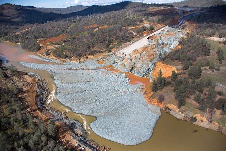 An aerial view of the damaged Oroville Dam spillway site with a huge debris in its diversion pool. (Dale Kolke / California Department of Water Resources/Handout)