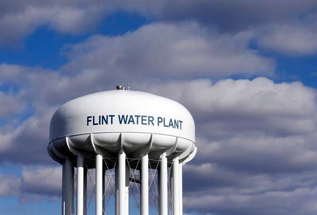 In this March 21, 2016 file photo, the Flint Water Plant water tower is seen in Flint, Mich.
