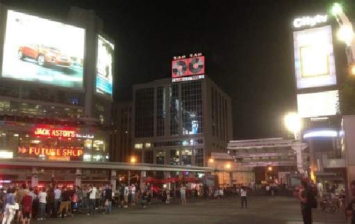 Composite image of the Sam The Record Man sign atop 277 Victoria Street in downtown Toronto.