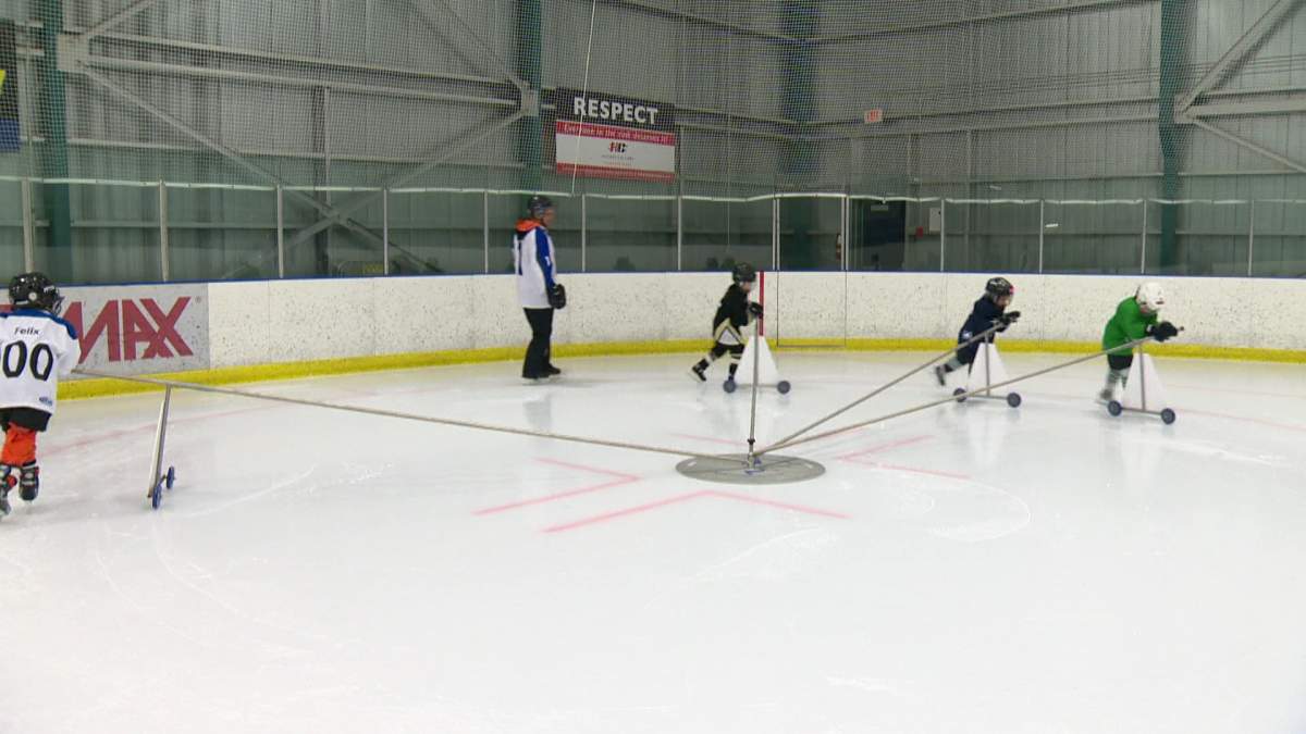 Founder Derek Fortier works with some novice hockey players on the Tornado’s Edge skating trainer in Calgary.