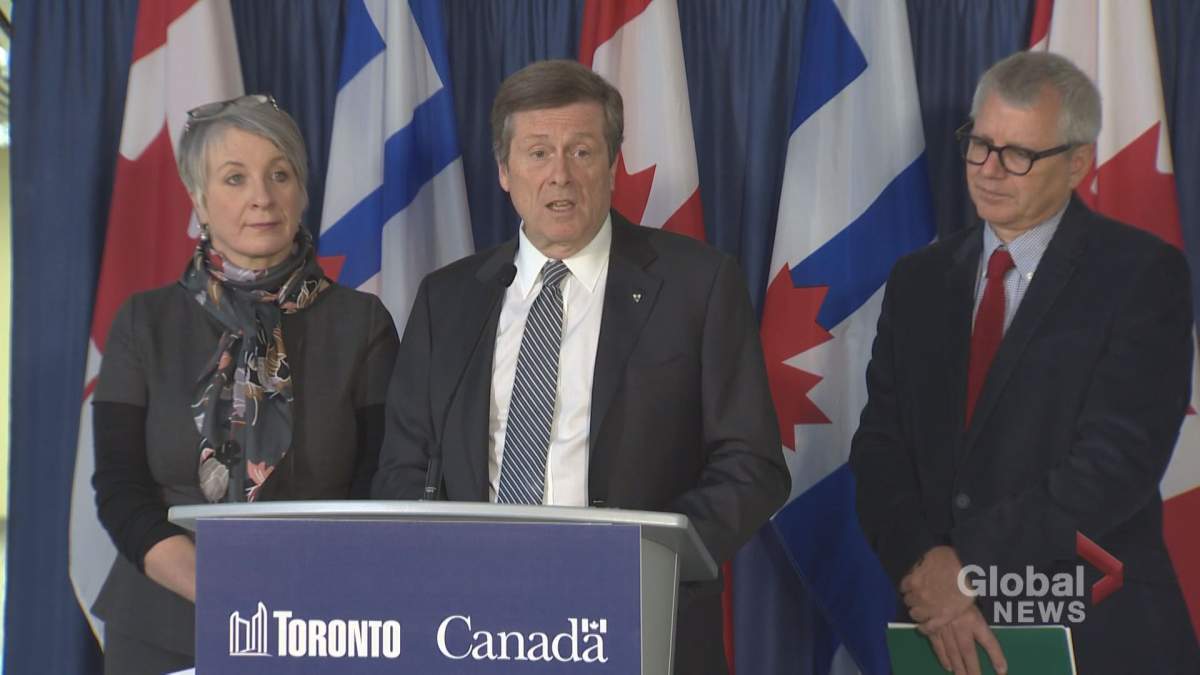 Mayor John Tory (centre) speaks to the media about a youth job funding announcement at city hall on March 14, 2017.