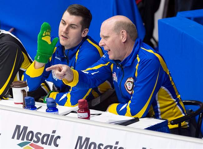 Canadian curling great Kevin Martin, coach of the Alberta team, talks with alternate Evan Asmussen during draw 6 action against New Brunswick at the Tim Hortons Brier curling championship at Mile One Centre in St. John's on Monday, March 6, 2017. 