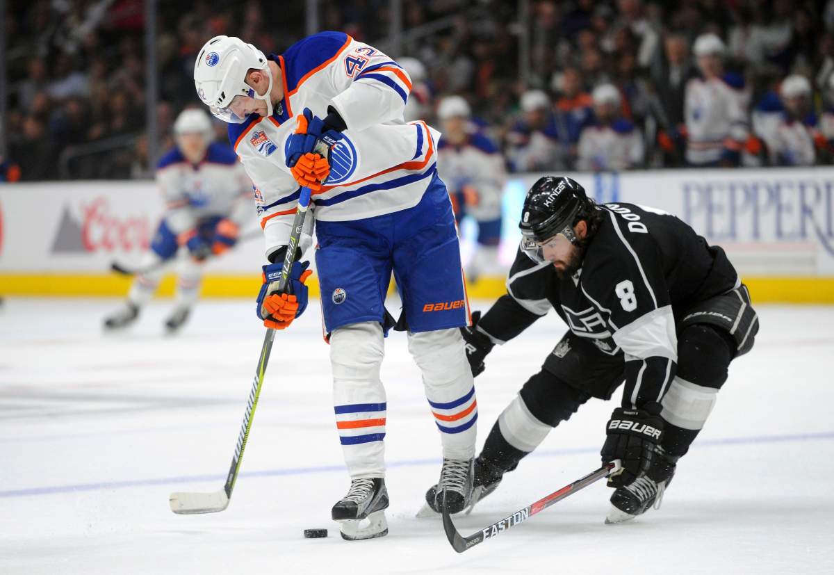 Edmonton Oilers left wing Anton Slepyshev (42), of Russia, advances the puck as Los Angeles Kings defenseman Drew Doughty (8) defends in the first period of an NHL hockey game, Tuesday, April 4, 2017, in Los Angeles.