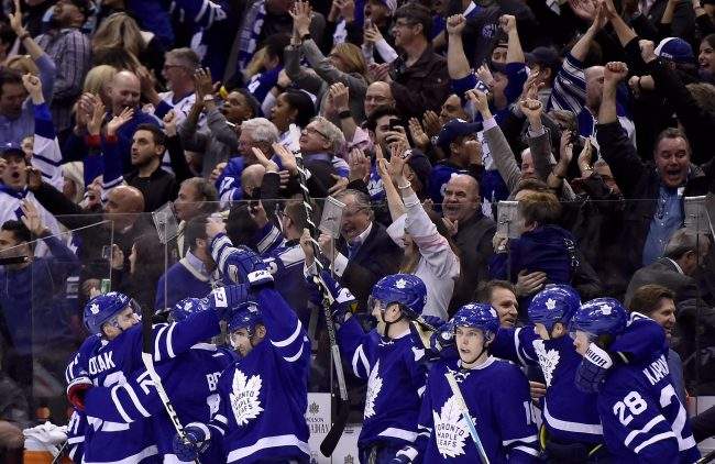 Toronto Maple Leafs celebrate an empty-net goal by centre Auston Matthews (34), not shown, during third period NHL hockey action in Toronto on Saturday, April 8.