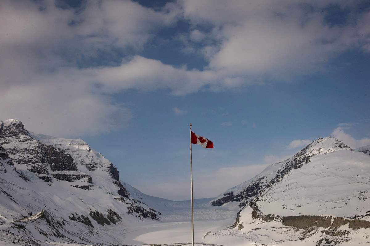 The Canadian flag flies over the Columbia Icefields’ Athabasca Glacier in Jasper National Park, on May 7, 2014.