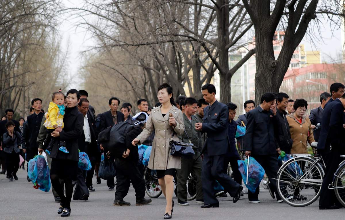 North Korean men and women leave an assembly area after rehearsals for celebrations ahead of the April 15 \”Day of the Sun,\” a national holiday marking the birthday of the late Kim Il Sung, leader Kim Jong Un\’s grandfather and North Korea\’s \”eternal president,\” Monday, April 10, 2017, in Pyongyang, North Korea.