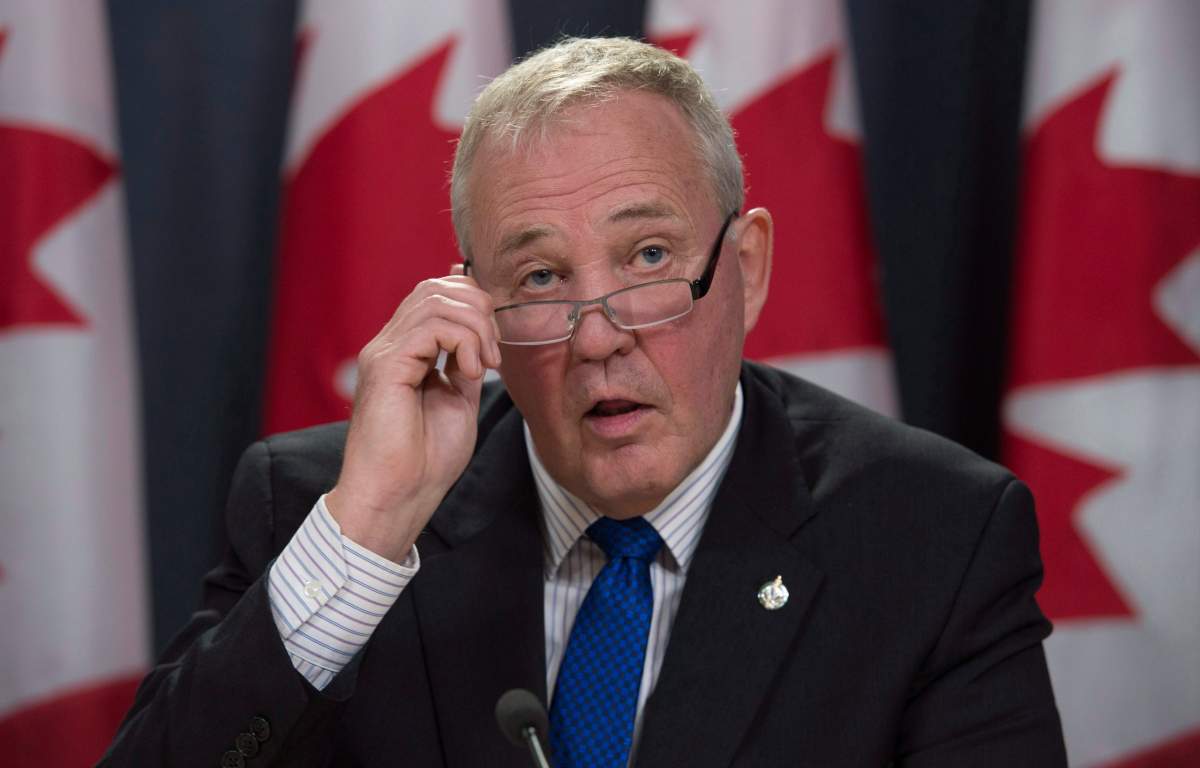 Parliamentary Secretary Bill Blair removes his glasses as he makes the opening statement regarding the legalization of marijuana during a news conference in Ottawa, Thursday April 13, 2017. 