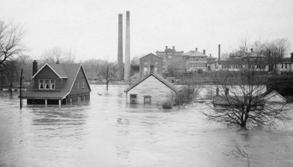 The flood resulted in the deaths of five people and destroyed more than 1,000 homes in the city. This photo shows homes along Front Street submerged by water.