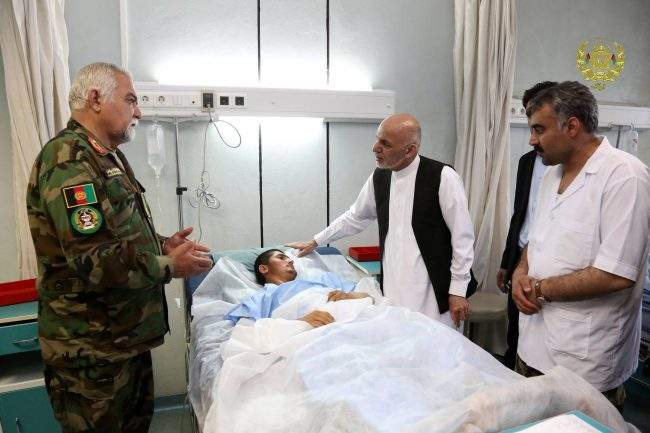 Afghanistan’s President Ashraf Ghani visits a victim wounded in April 21’s attack on an army headquarters, in Mazar-i-Sharif, northern Afghanistan April 22, 2017.