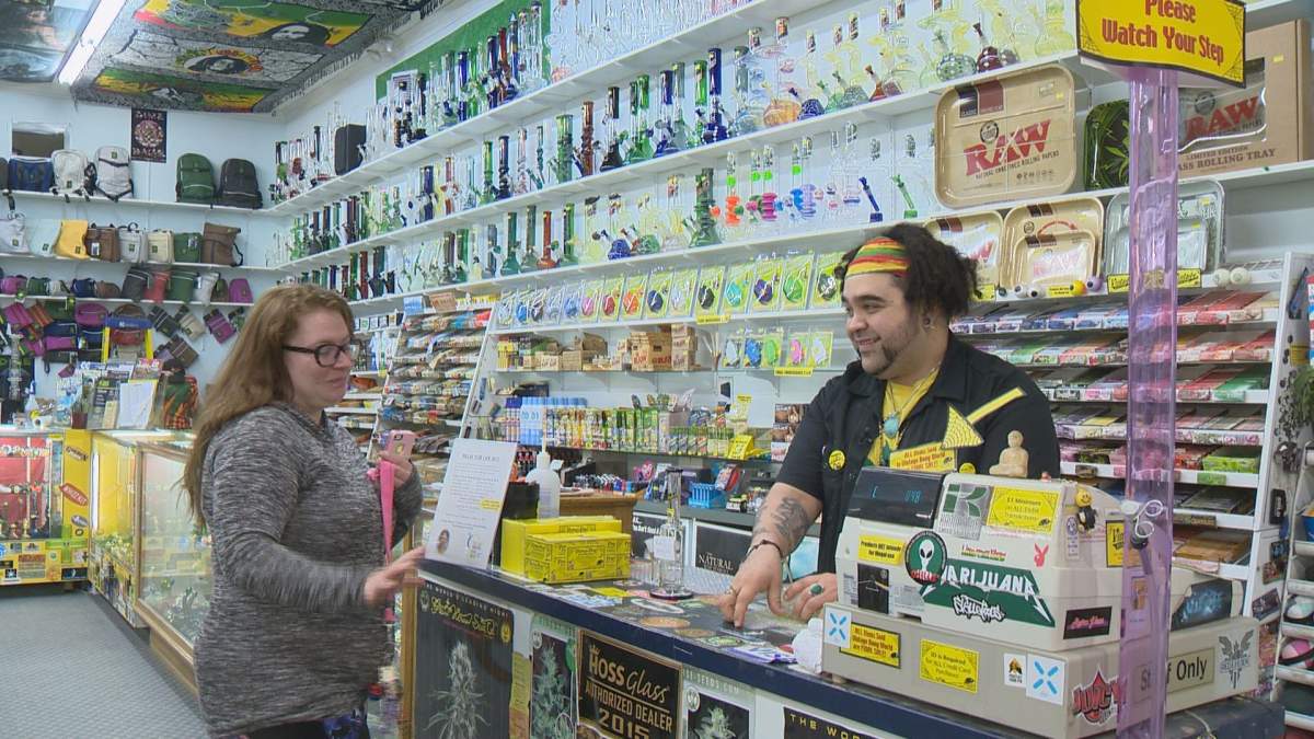 Roberto “Buzzrock” Apodaca assists a customer at Vintage Vinyl & Hemp Emporium.