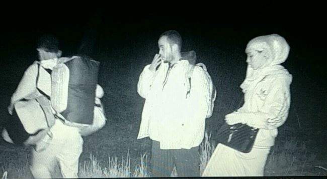 A wildlife camera captures asylum seekers crossing a field near Pembina, N.D. in November, 2016.