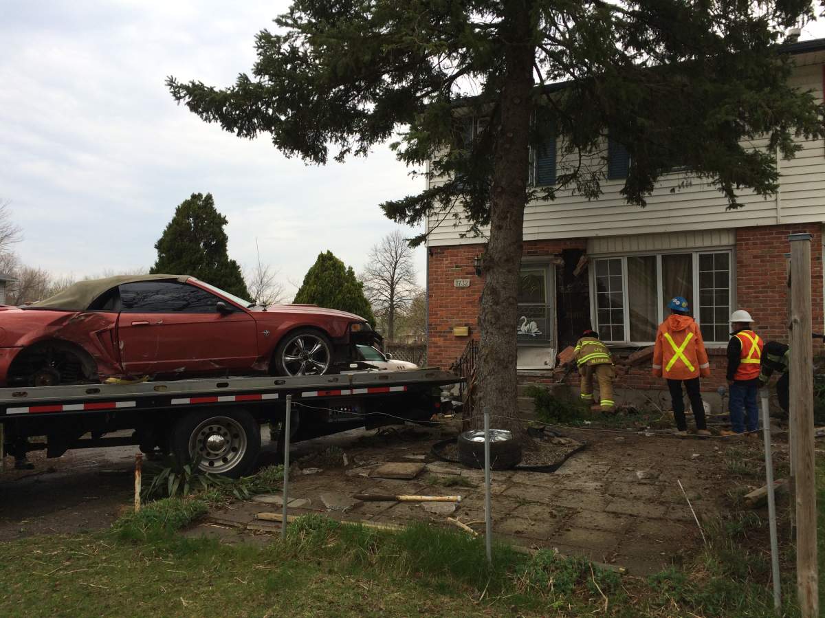 Police tow away vehicle that struck a home on Culver Drive on Wednesday, April 19, 2017.