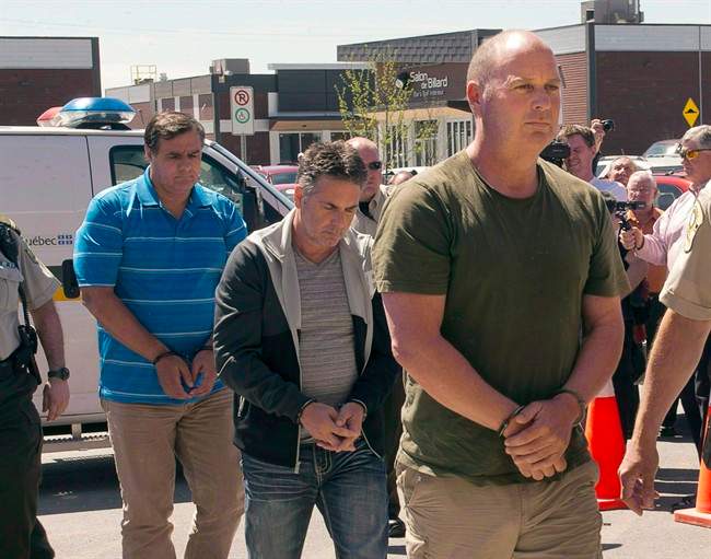 Former Montreal Maine and Atlantic Railway Ltd. employees Tom Harding, right, Jean Demaitre, centre, and Richard Labrie are escorted by police to appear in court in Lac-Megantic, Que., on Tuesday, May 13, 2014. The trial for the three men is set to being on Monday in Sherbrooke. Sunday, Oct. 1, 2017.