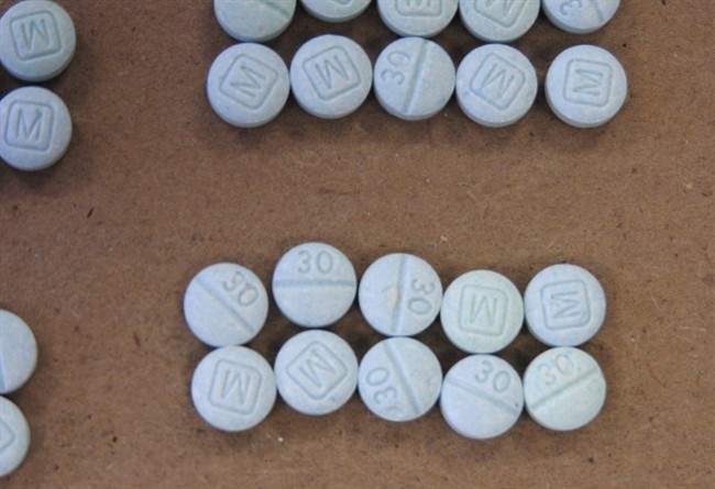 Fentanyl pills are shown in an undated file photo. Police say they seized 55 fentanyl pills and charged three people in a drug trafficking bust in Saskatoon.