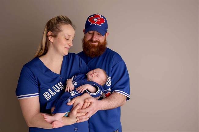 Elise and Brandon Phillippo and their baby Kellan Xavier are shown in a family handout photo. It's been a busy year for Elise Phillippo and her husband Brandon. They got hitched, bought a house and had a baby - all against the backdrop of the costliest natural disaster in Canadian history. 