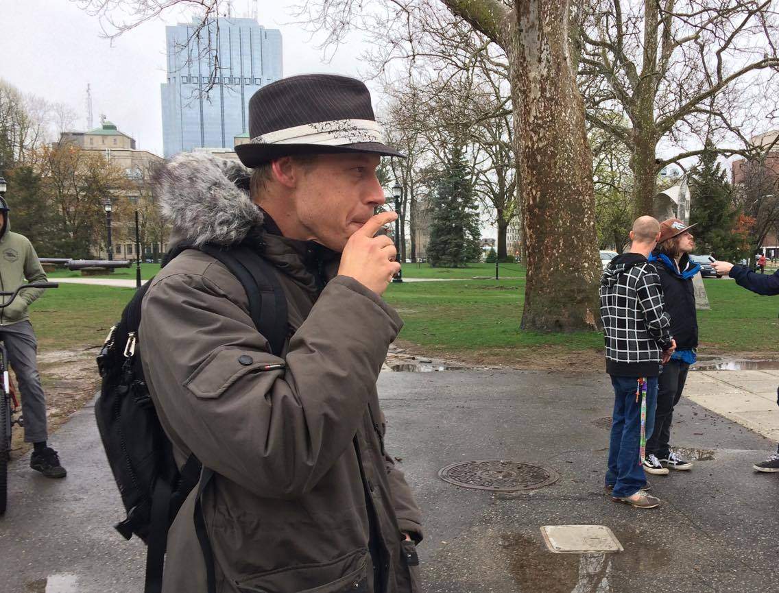A man smokes a joint during a 4/20 rally at Victoria Park, on April 20, 2017.