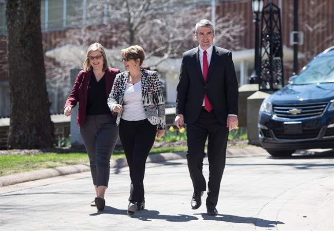Nova Scotia Premier Stephen McNeil, right, walks toward Government House with his daughter Colleen, left, and wife Andre to ask the Lieutenant Governor to dissolve the House in order to call a provincial election in Halifax on Sunday, April 30, 2017. 