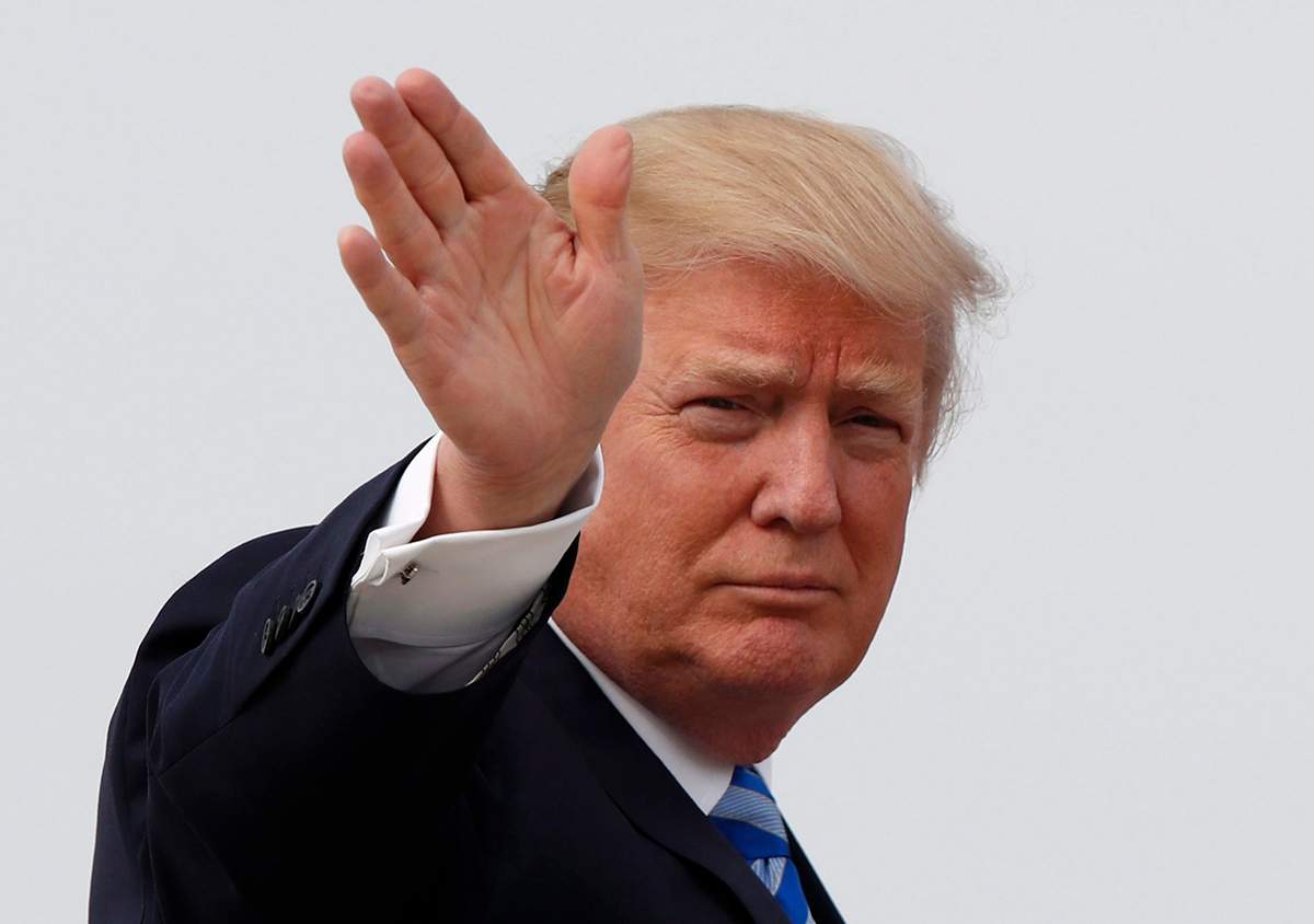 President Donald Trump waves as he boards Air Force One before his departure from Andrews Air Force Base, Md., Thursday, April 13, 2017, to his Mar-a-Largo resort in Florida.