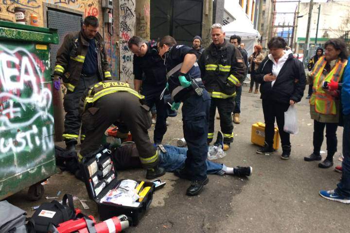 First responders tend to an overdose victim in Vancouver's Downtown East Side.