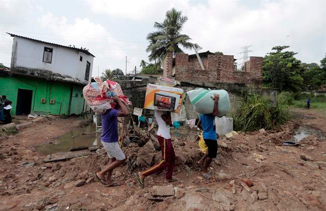 Sri Lankans affected by a garbage dump collapse salvage their belongings in Meetotamulla, on the outskirts of Colombo, Sri Lanka, Saturday, April 15, 2017. ital Colombo collapsed destroying houses,