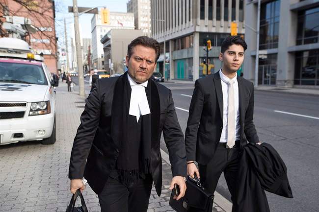 Amedeo DiCarlo, the lawyer for Karim Baratov, left, arrives at the courthouse in Hamilton, Ont., on Tuesday, April 11, 2017. 