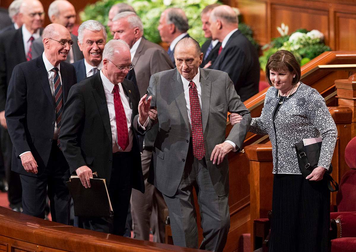 President Thomas S. Monson, center, of The Church of Jesus Christ of Latter-day Saints, walks with his daughter, Ann Dibb, right, as he leaves the morning session of the two-day Mormon church conference Saturday, April 1, 2017, in Salt Lake City. 