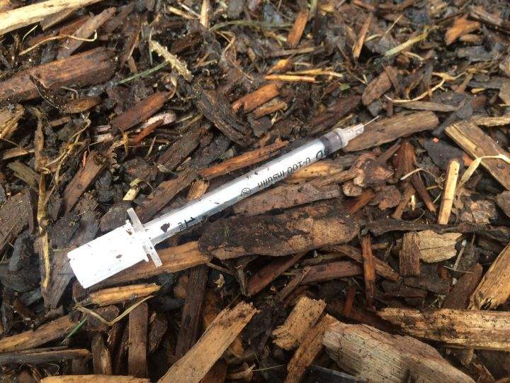 A syringe is seen on the ground in this file photo.