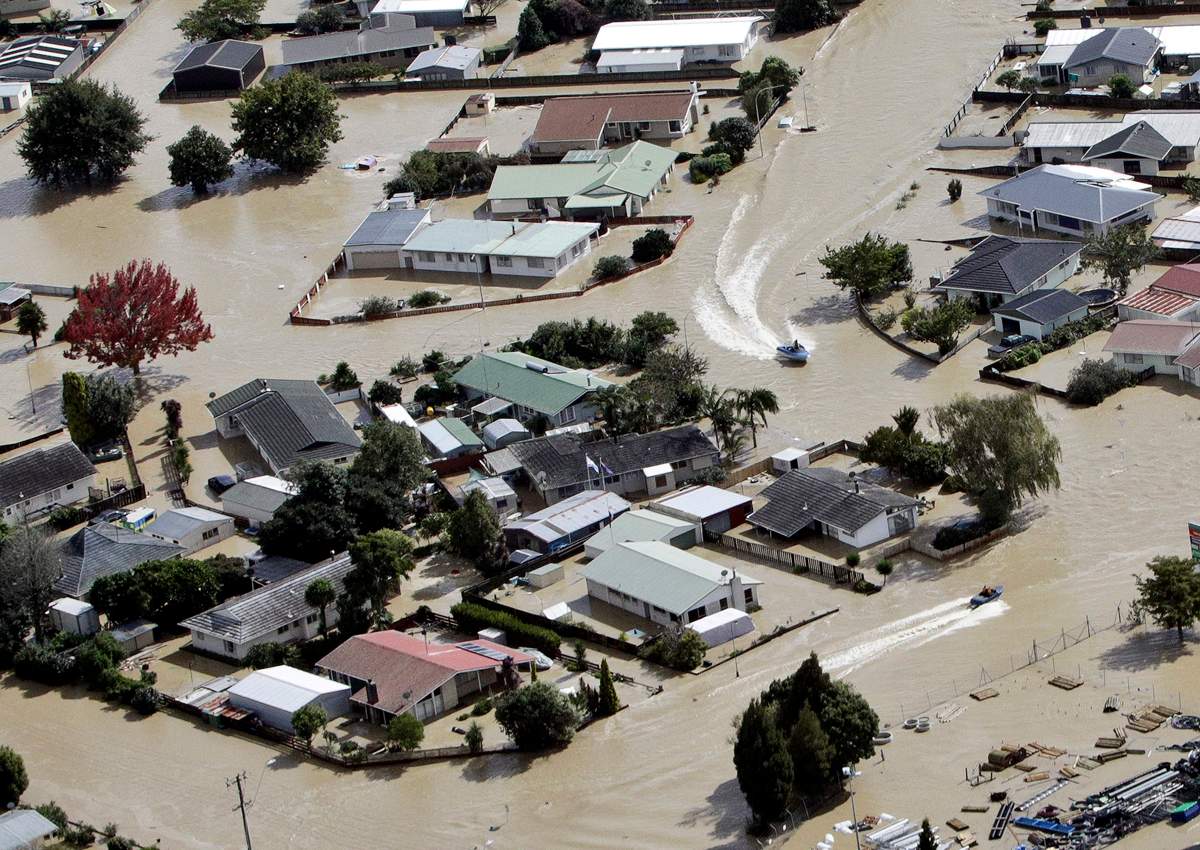 Jet boats drive through the flooded streets of the North Island town of Edgecumbe in New Zealand, Thursday, April 6, 2017. (Andrew Warner/The Bay of Plenty Times via AP)