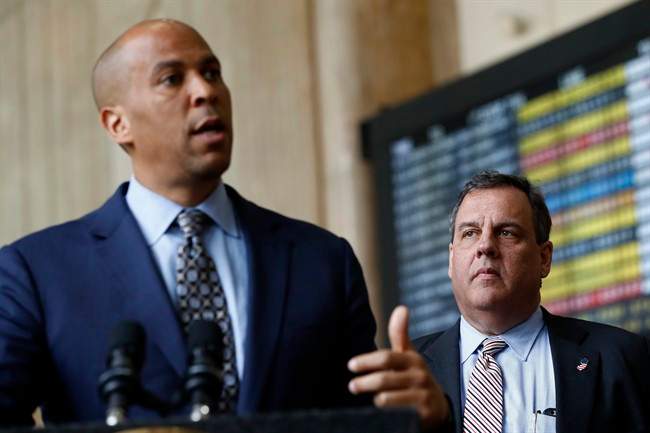 U.S. Sen. Cory Booker, left, speaks as New Jersey Gov. Chris Christie listens during a news conference at Newark Penn Station, Wednesday, April 19, 2017, in Newark, N.J. 