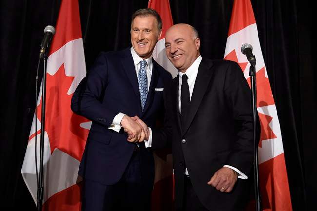 Conservative Party leadership candidate Maxime Bernier (left) shakes hands with Kevin O'Leary at a news conference in Toronto, Wednesday, April 26, 2017, after it was announced that O'Leary had quit the leadership race and thrown his support behind Bernier. 