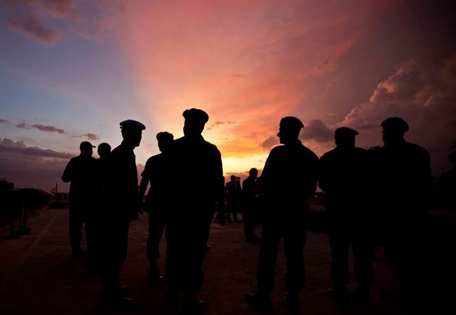 FILE – This Monday, July 11, 2011, file photo shows silhouettes of UN peacekeepers from Brazil at the airport in Port-au-Prince, Haiti. (AP Photo/Eduardo Verdugo)