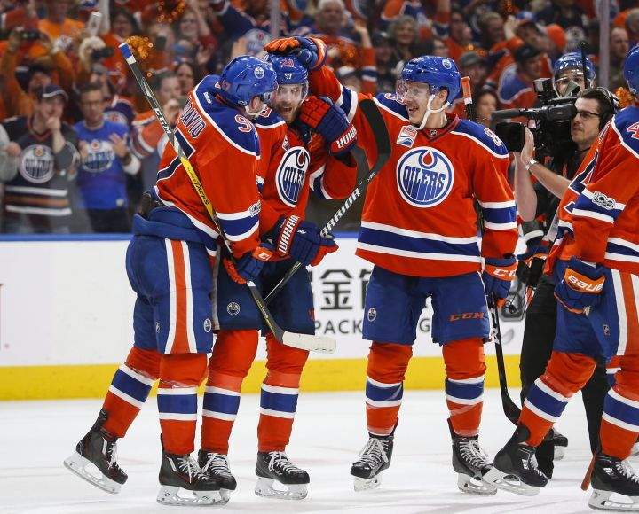 Edmonton Oilers’ Connor McDavid, left, Leon Draisaitl, centre, of Germany, and Matthew Benning celebrate their win following overtime NHL hockey round one playoff action against the San Jose Sharks, in Edmonton, Thursday, April 20, 2017.