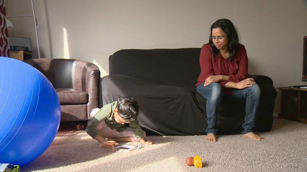 Vigya Singh watches her daughter, Kavya, play.